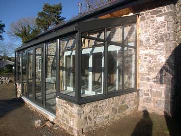 Mrs L. Cilcain North Wales : refurbishment . Installation of a HWl Ornate Thermally broken Aluminium Roof system glazed with Hytherm Clear units . Windows and doors Allstyle PP Coated Aluminium double glazed with Pilkington Activ K 